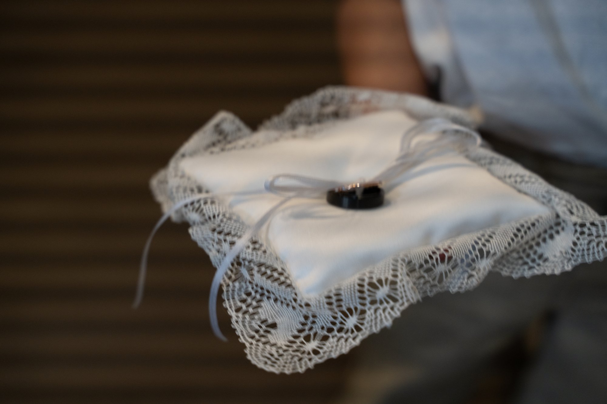 Wedding ring bearer pillow photo showing horizontal LED rolling-shutter banding bars running across the entire frame